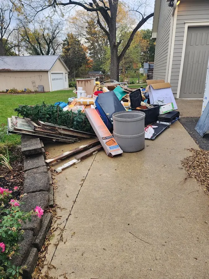 Dumpster being loaded with debris for 30 Yard Dumpster Rental in Mineola